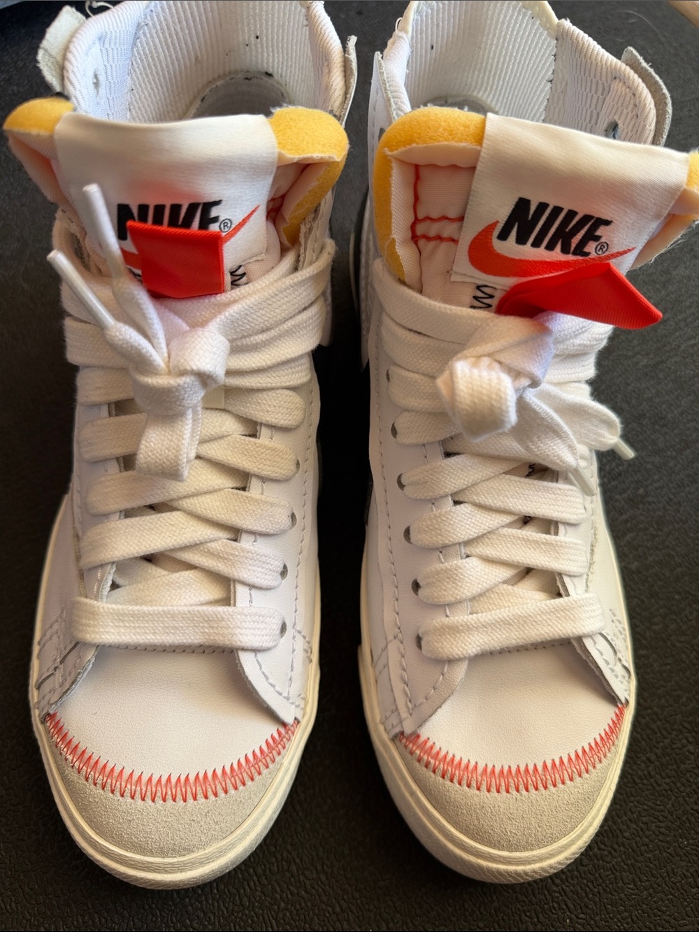 Nike White High-Top Sneakers with Orange and Yellow Accents
